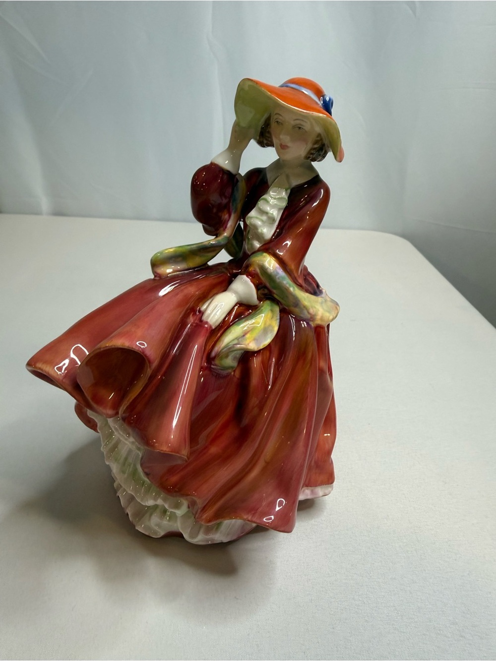 Royal Doulton Lady Figurine in Red and Cream with Orange Hat